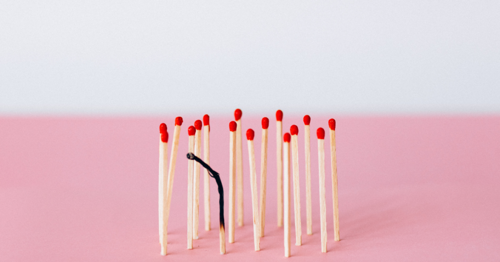 matches laid out with one match in the middle burnt out