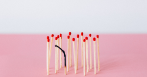 matches laid out with one match in the middle burnt out